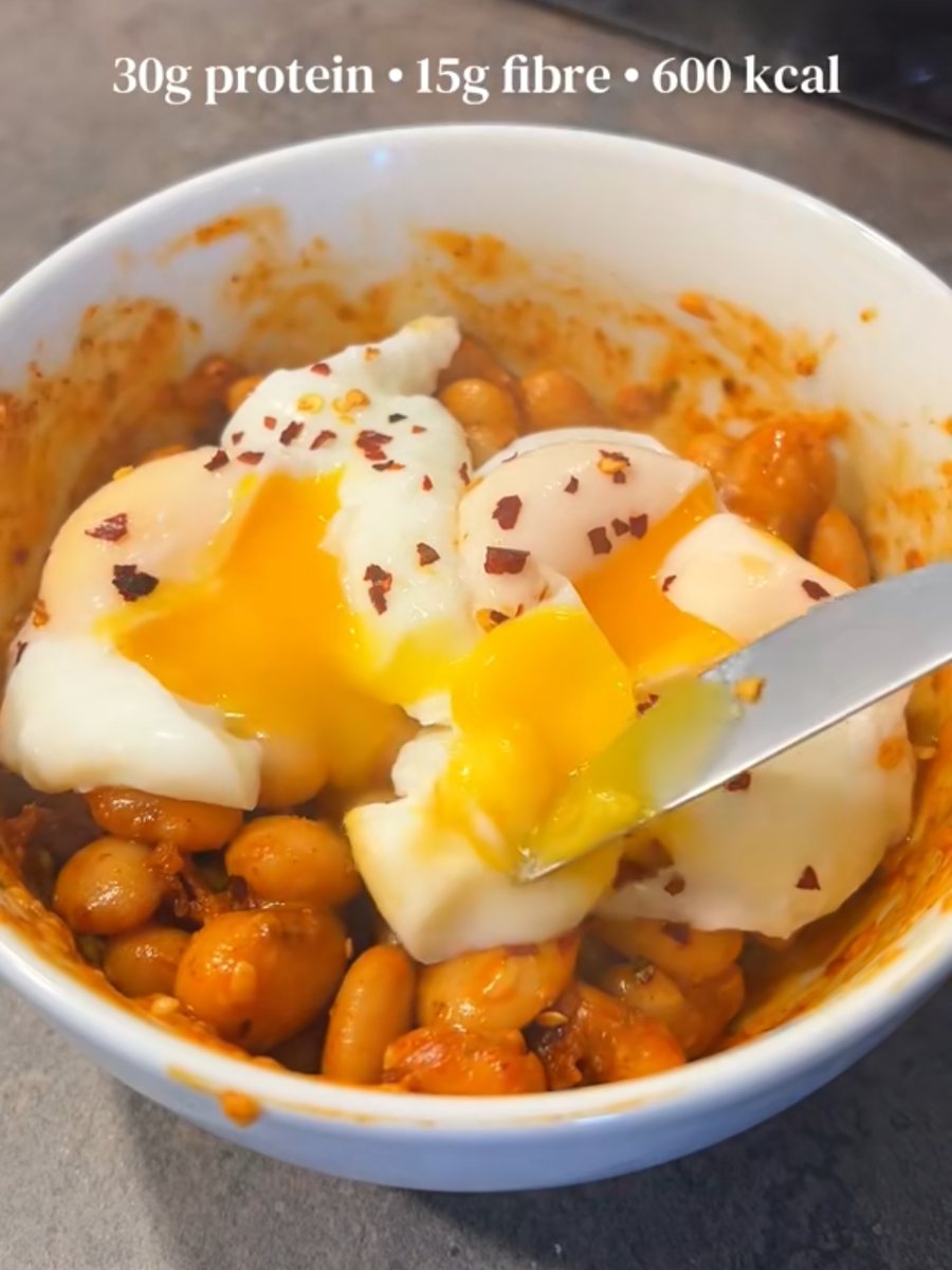Butter beans in a paprika sauce topped with two poached eggs and chilli flakes