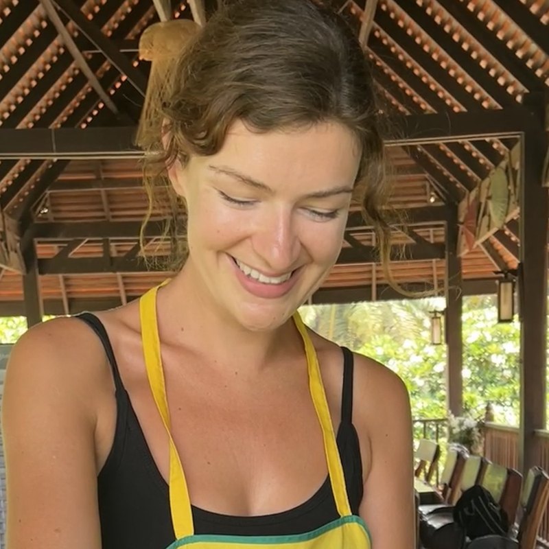 Charlotte smiling while cooking