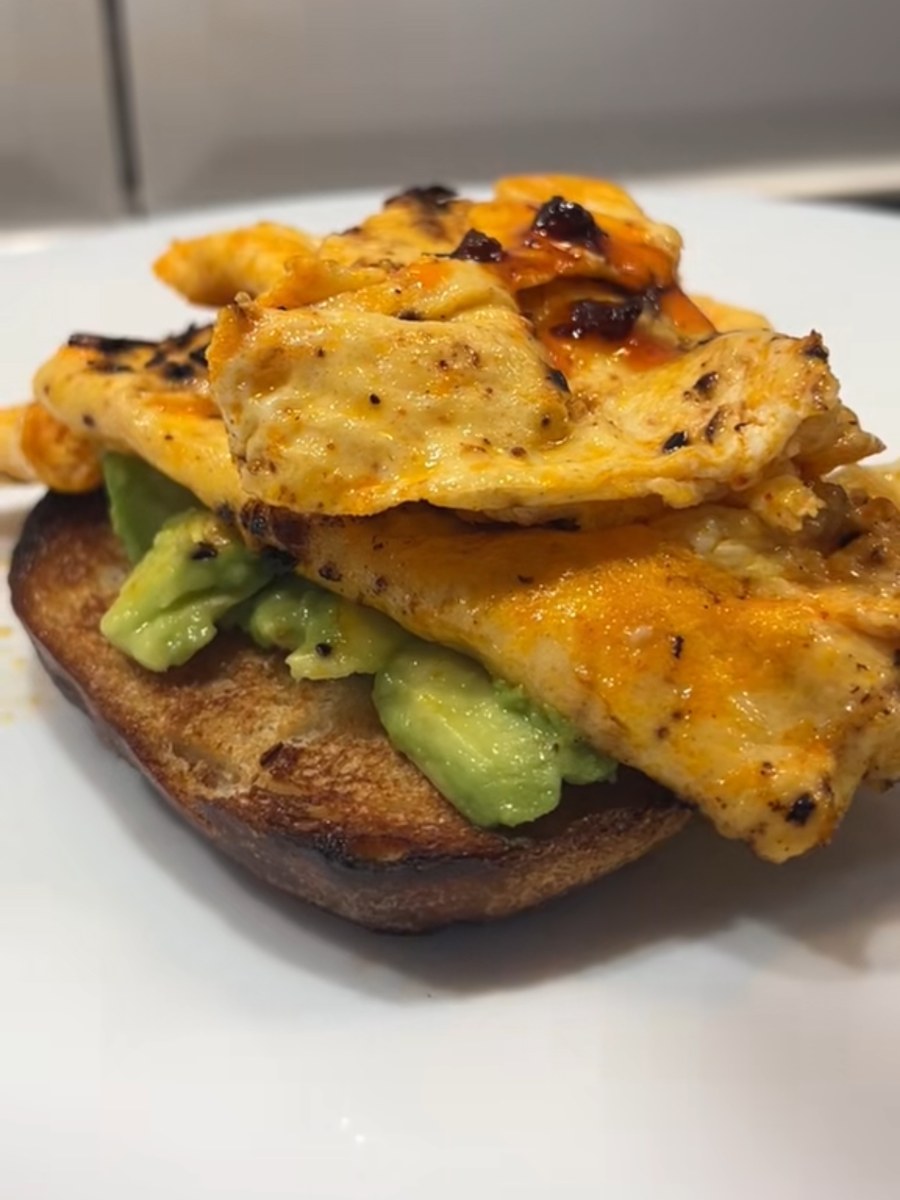 Crispy chilli oil scrambled eggs piled on toasted sourdough with chunks of avocado