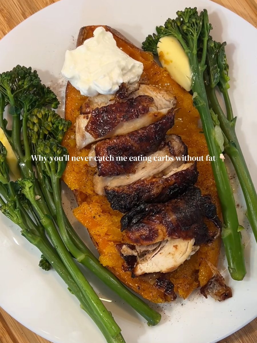 Sliced sticky glazed chicken thigh on a sweet potato half with tenderstem broccoli and cottage cheese